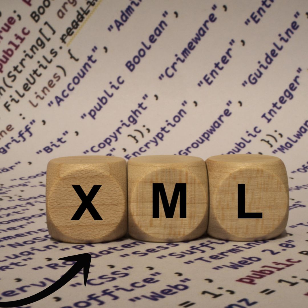 Wooden blocks spelling 'XML' in front of a background of code, symbolizing website architecture and SEO optimization.